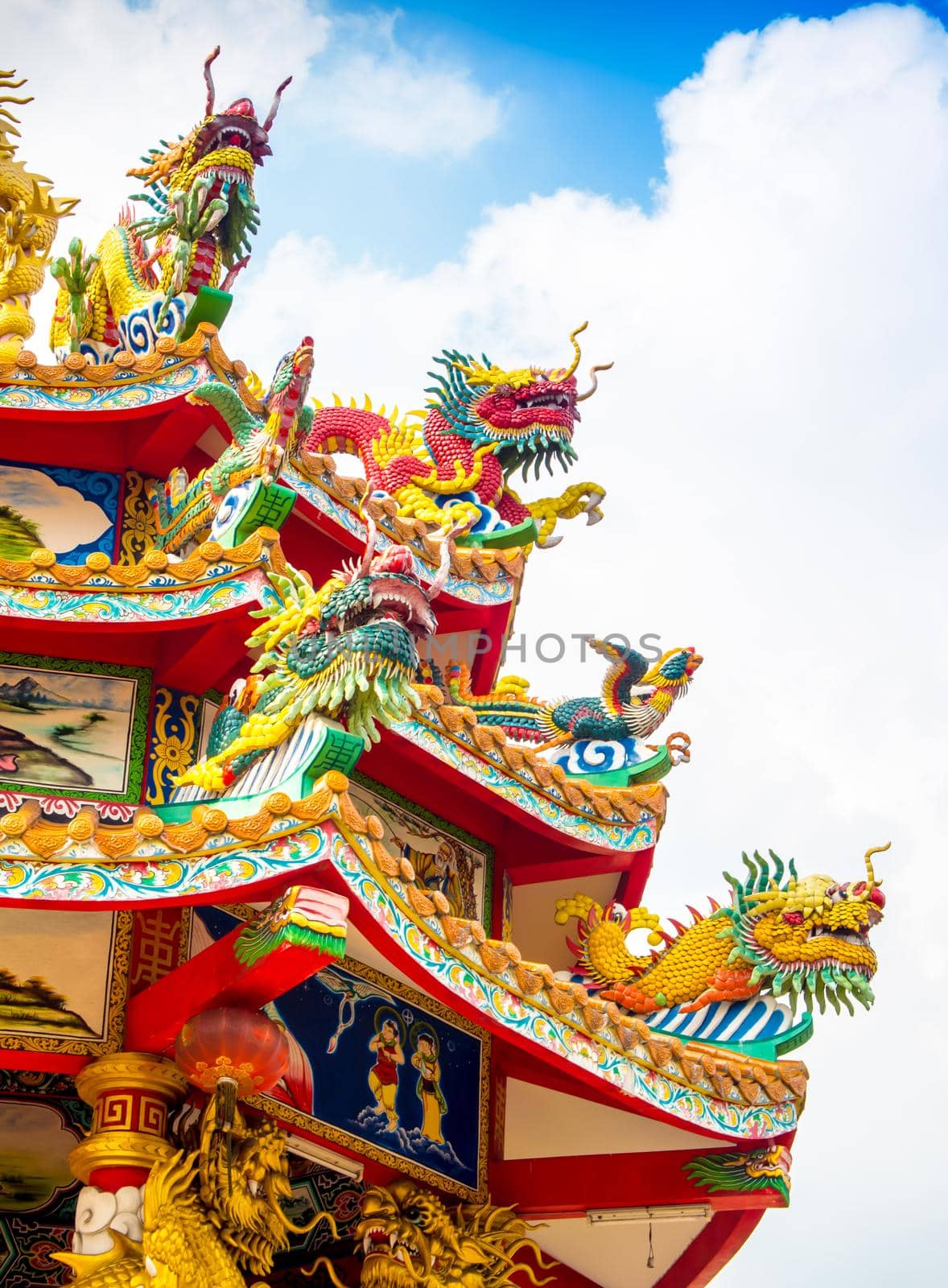 Colorful chinese dragon and swan statues adorned the rooftops of pavilions in Chinese religious venues