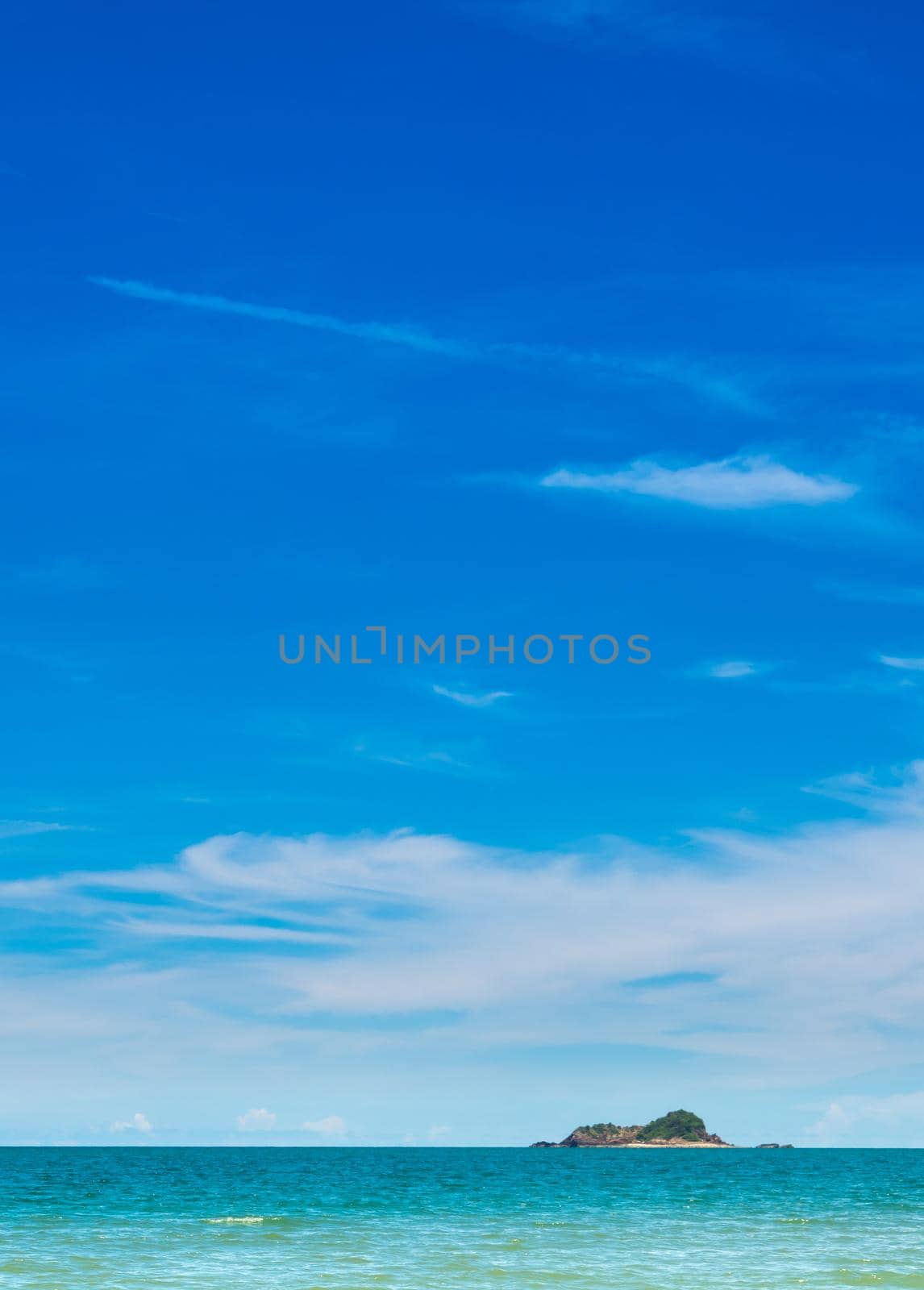 Wide view of sea and the mountain on island with blue sky background