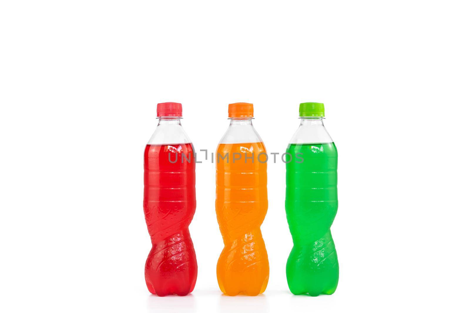 Colorful colors red orange and green drinks in a plastic bottle isolated on white background.