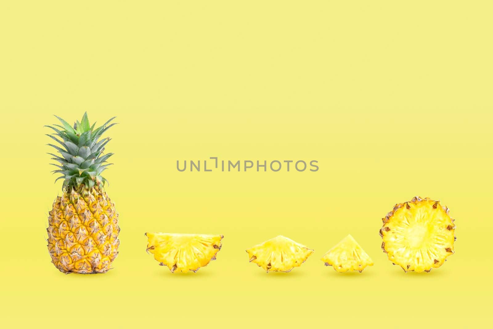 Collection of group pineapples and sliced isolated on yellow pastel colors background.