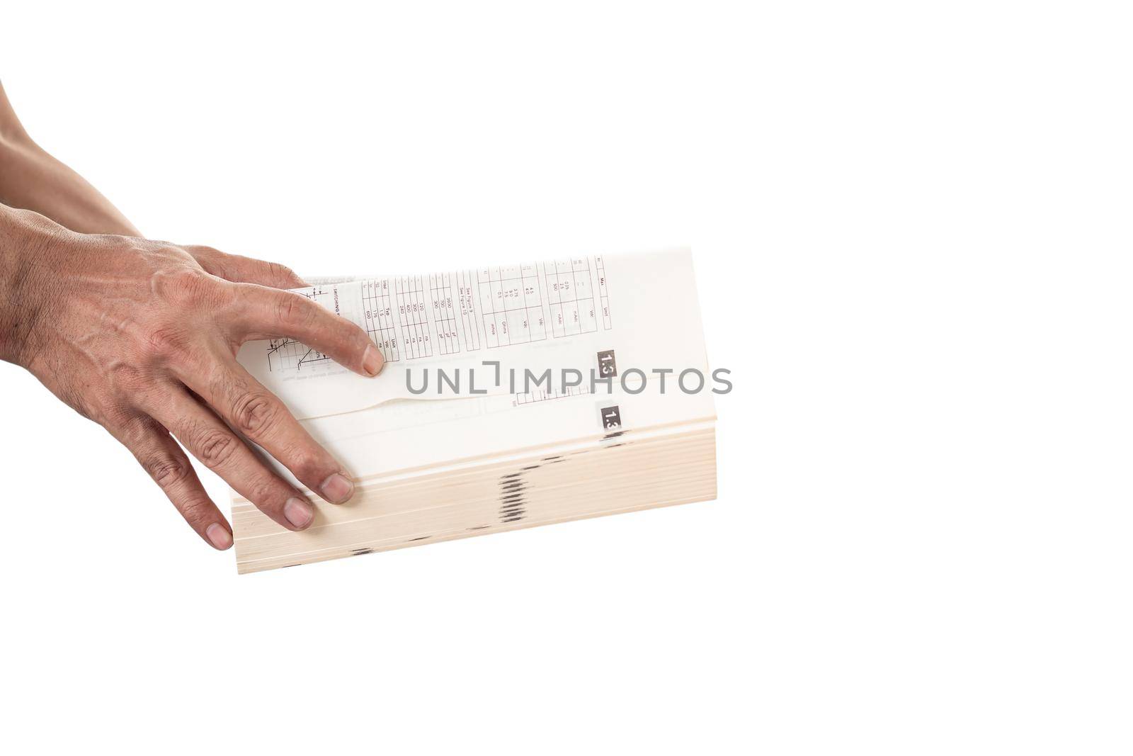 Man's hand holding and opening a thick book on white background. by wattanaphob