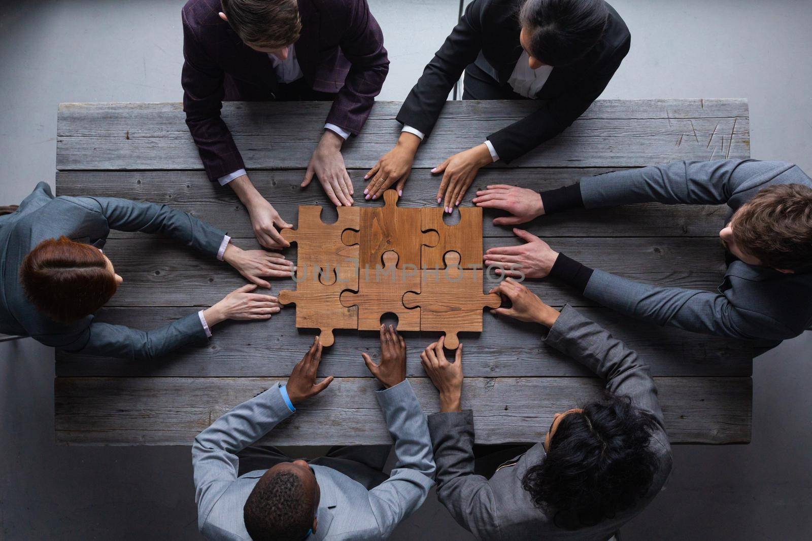 Business teamwork with puzzle by ALotOfPeople