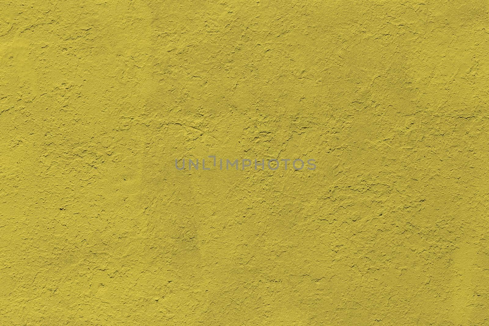 background and texture of flat thick painted matte yellow surface under direct sunlight - new paint over fragments of old peeled one