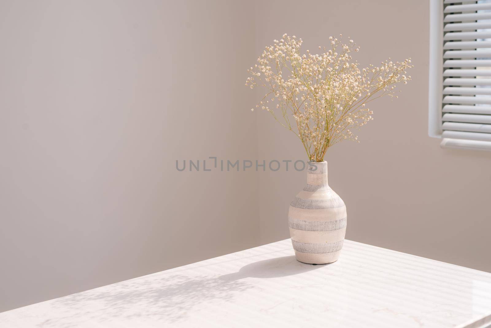 Beautiful spring flowers in vase on window background. by makidotvn