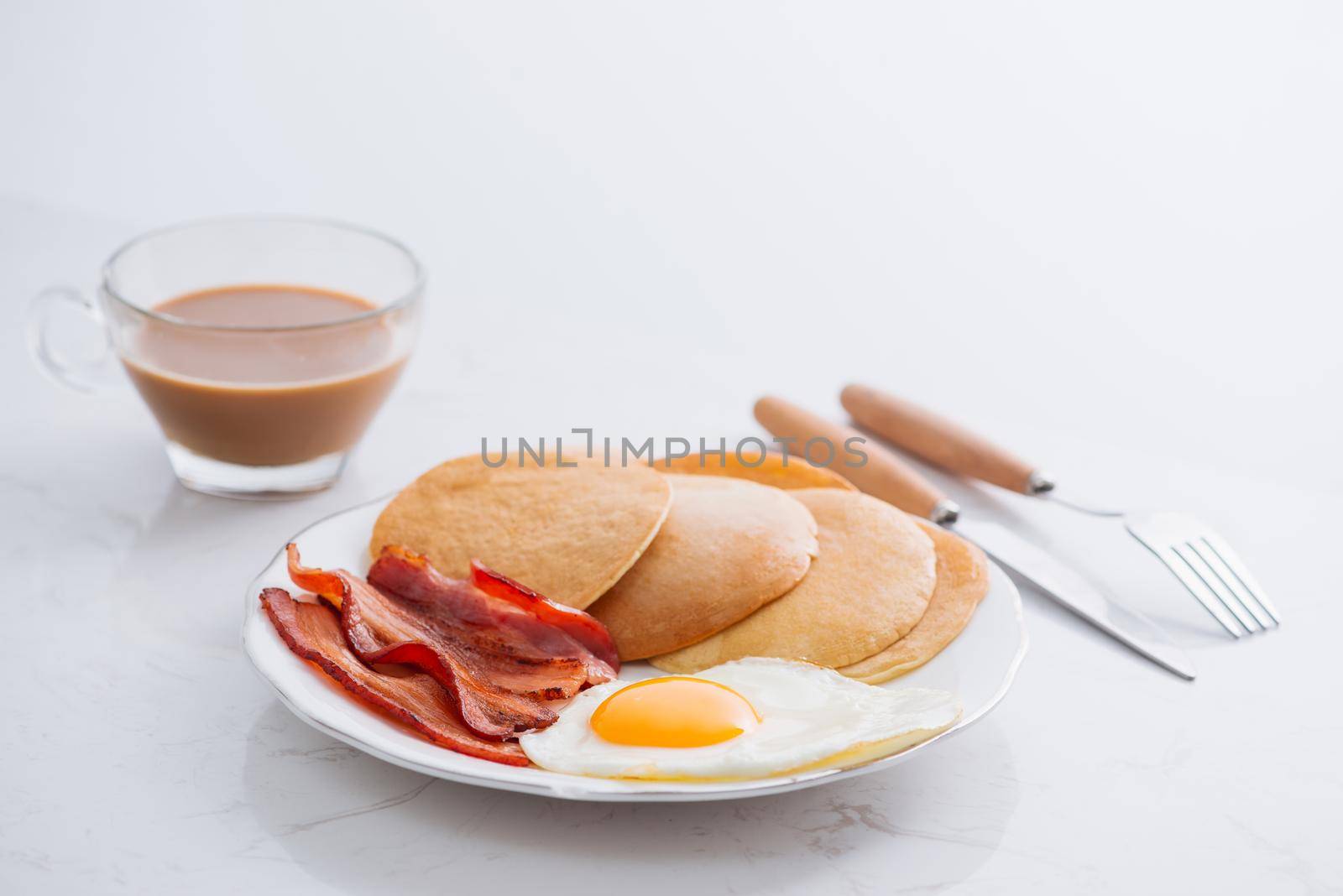 Healthy Full American Breakfast with Eggs Bacon and Pancakes