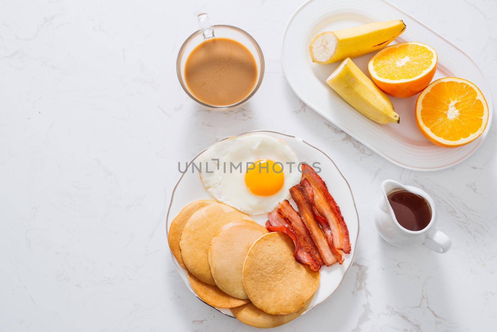 Healthy Full American Breakfast with Eggs Bacon and Pancakes