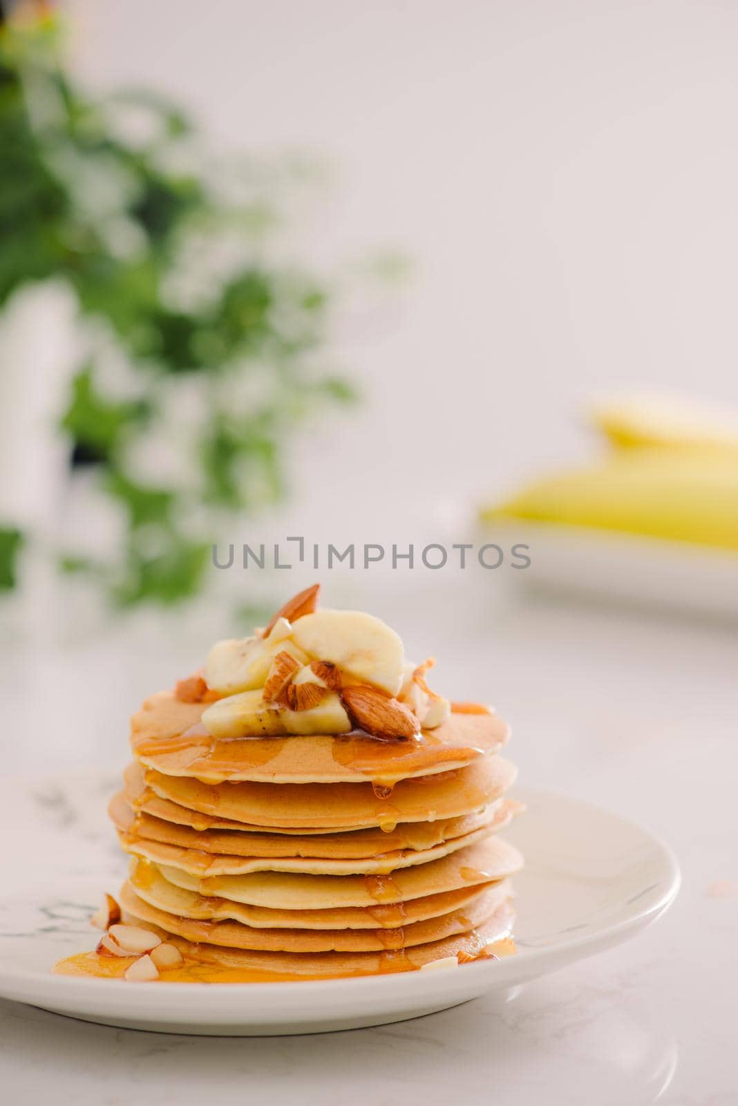 banana cashew pancakes with bananas and salted caramel sauce. the toning. selective focus by makidotvn