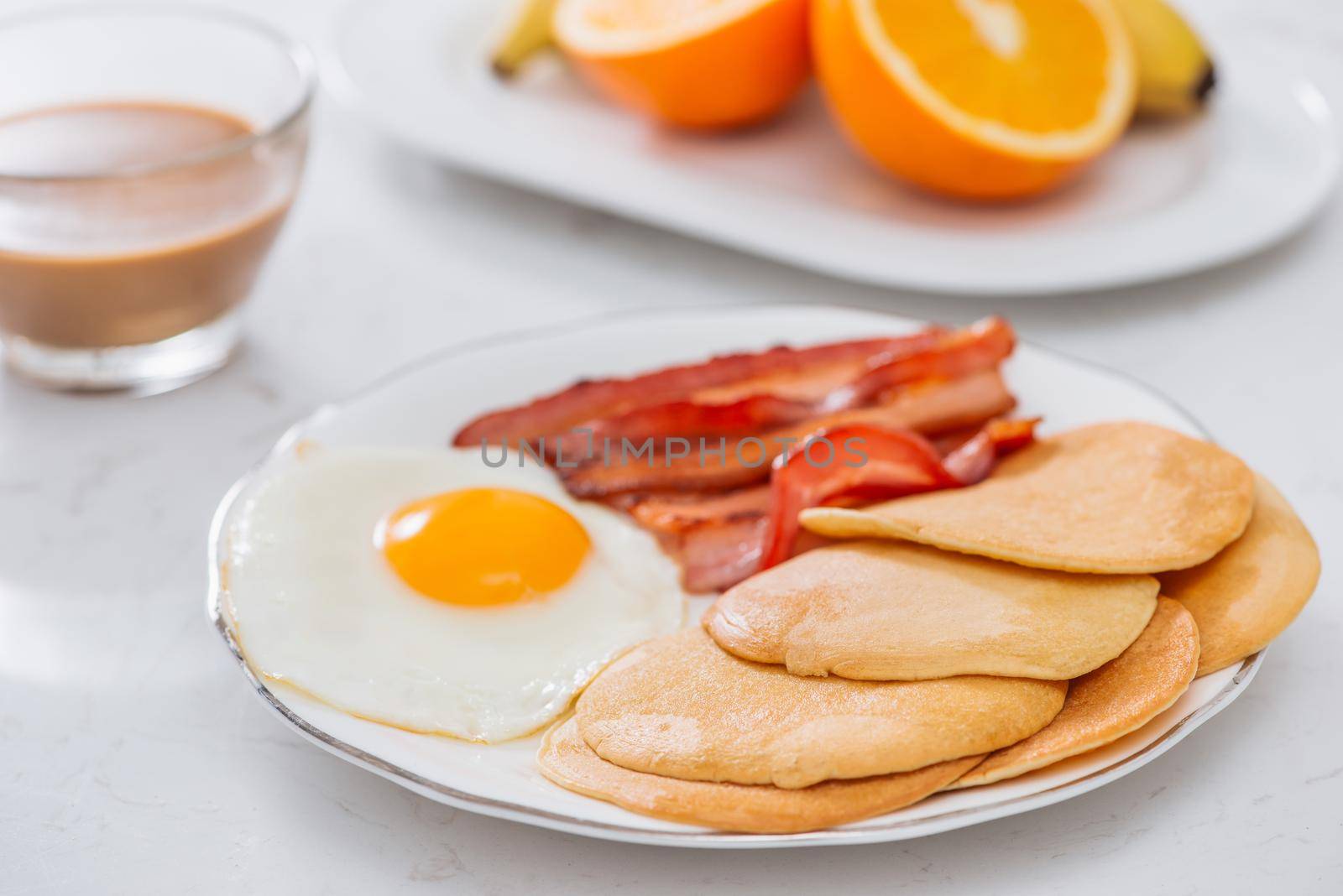 Healthy Full American Breakfast with Eggs Bacon and Pancakes by makidotvn