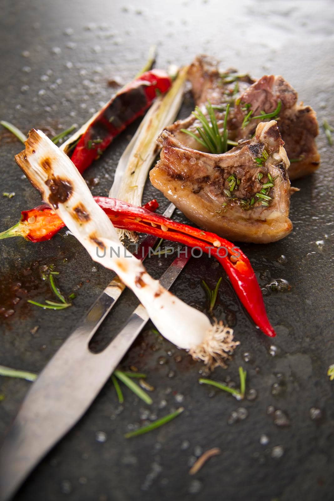 Lamb chops cooked on the grill with leek and red pepper