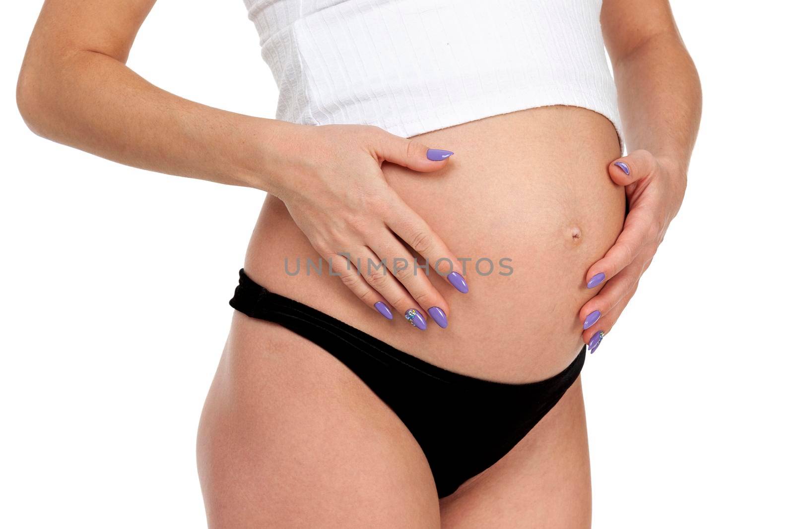 Pregnant woman posing against white background, isolated by Nobilior