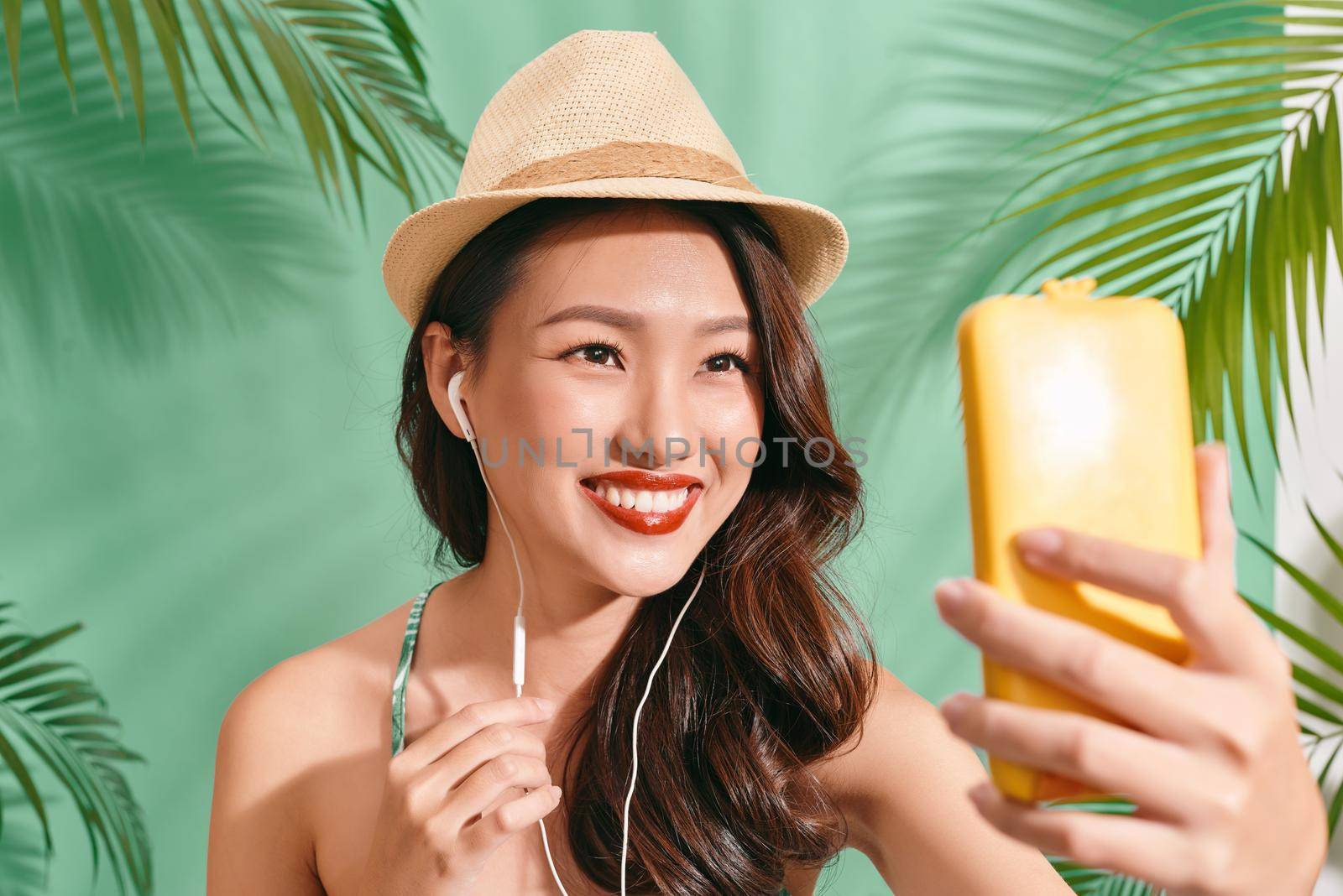 Asian women selfie herself on blue backgound. Asian women happy for travel on summer