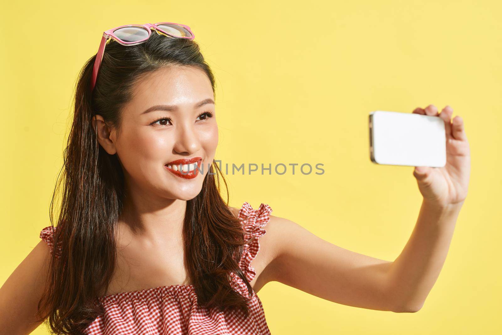 Asian women holding camera on yellow background. Asian women happy for travel on summer by makidotvn