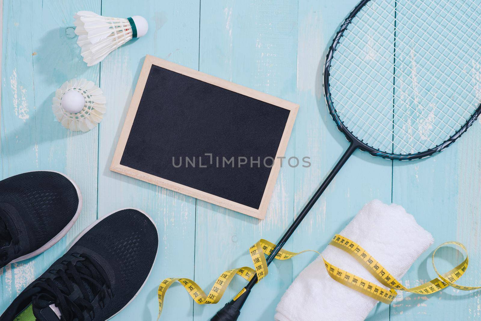 Top view of sport equipments, clock, tape measure, shoes, water bottle, towel, badminton racket and shuttlecock, Healthy lifestyle and fitness concept by makidotvn