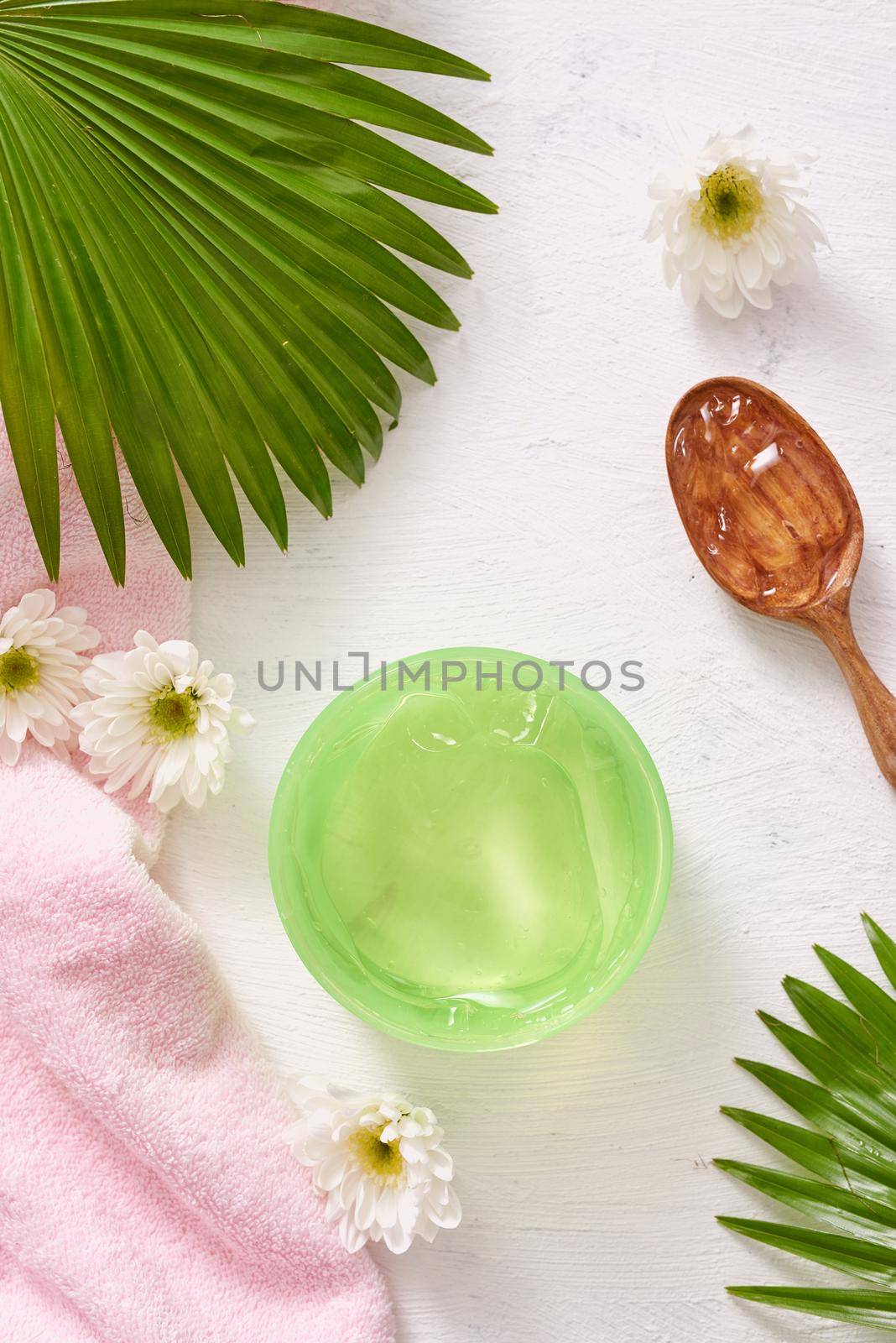 spa setting with cosmetic gel, leaves on white table background by makidotvn
