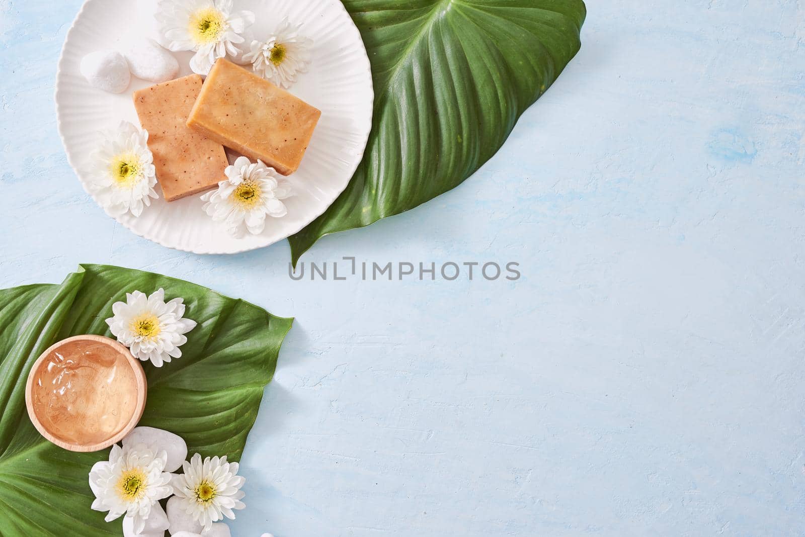 Beauty, spa, body care, bath and natural cosmetics concept - close up of handmade soap bars on white table
