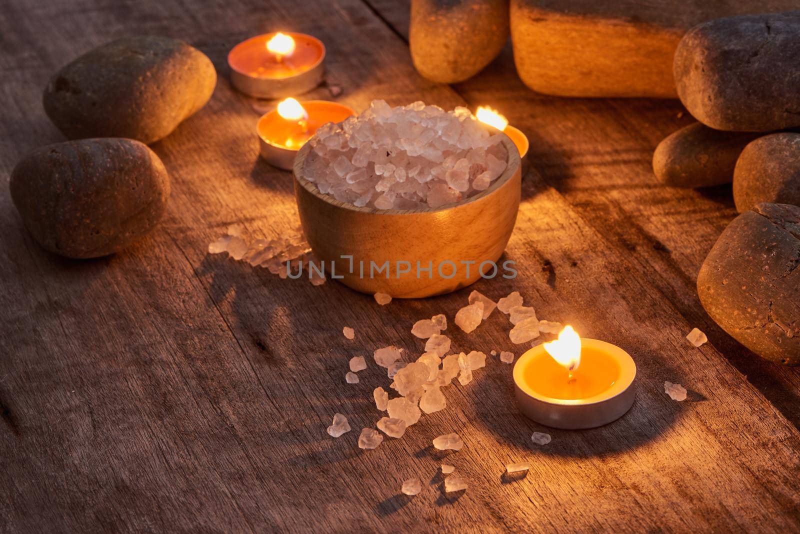 Spa accessories. Sprigs of a Christmas tree, many multi-colored pieces of soap, many different shapes of bottles for a bathroom. Body scrub. Light brick and white wooden as a background