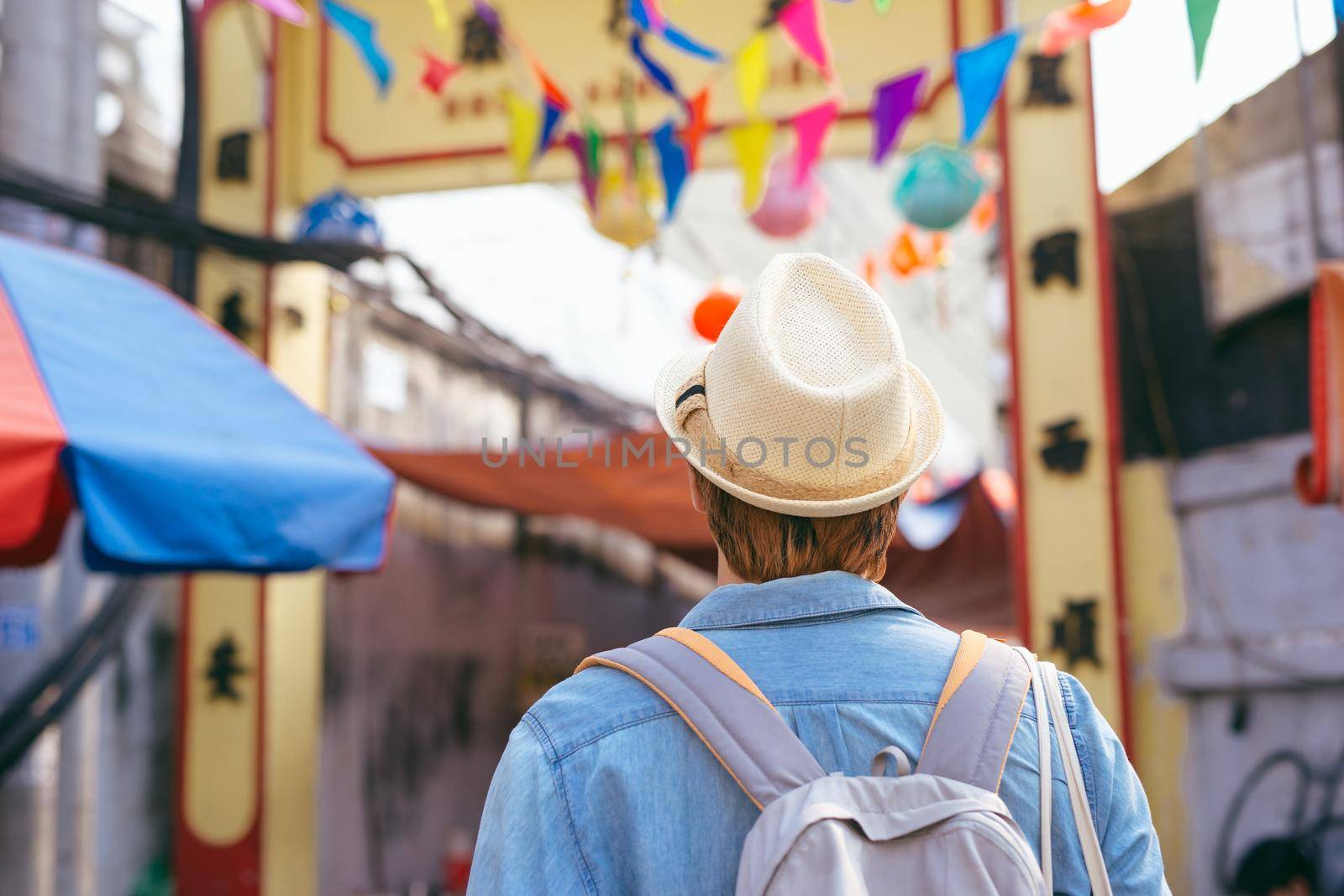 Young asian man traveler shopping walking on street market by makidotvn