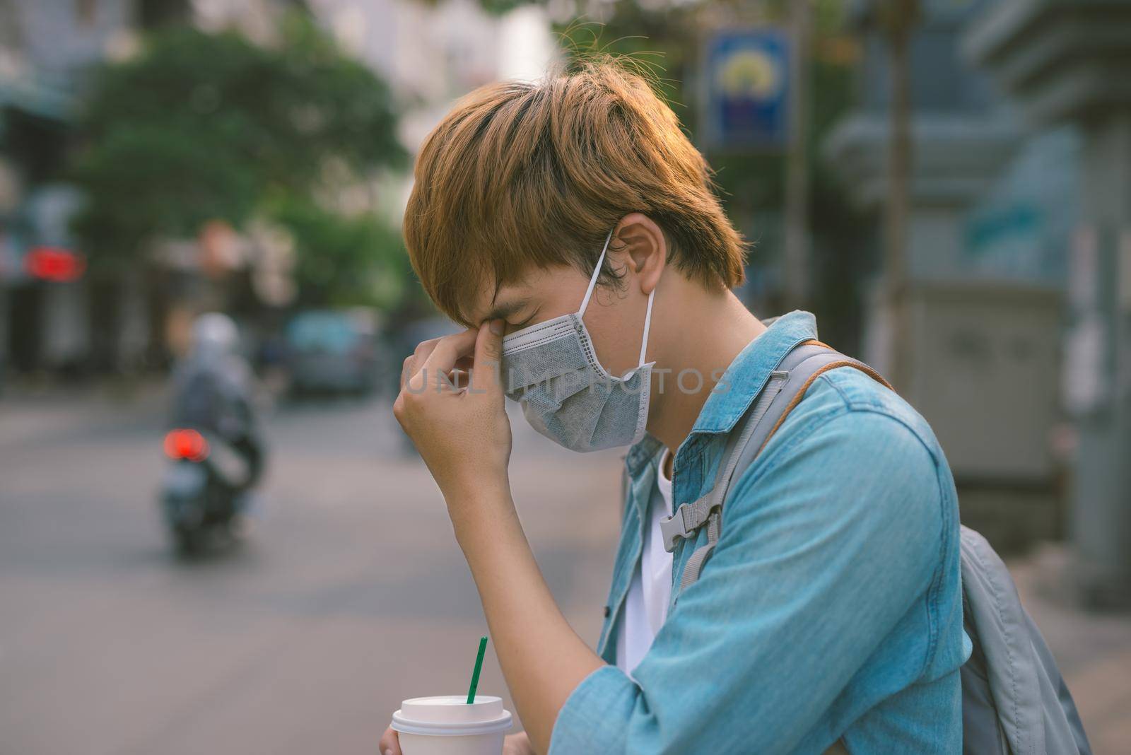 Sick Asian man in face mask walking outdoors