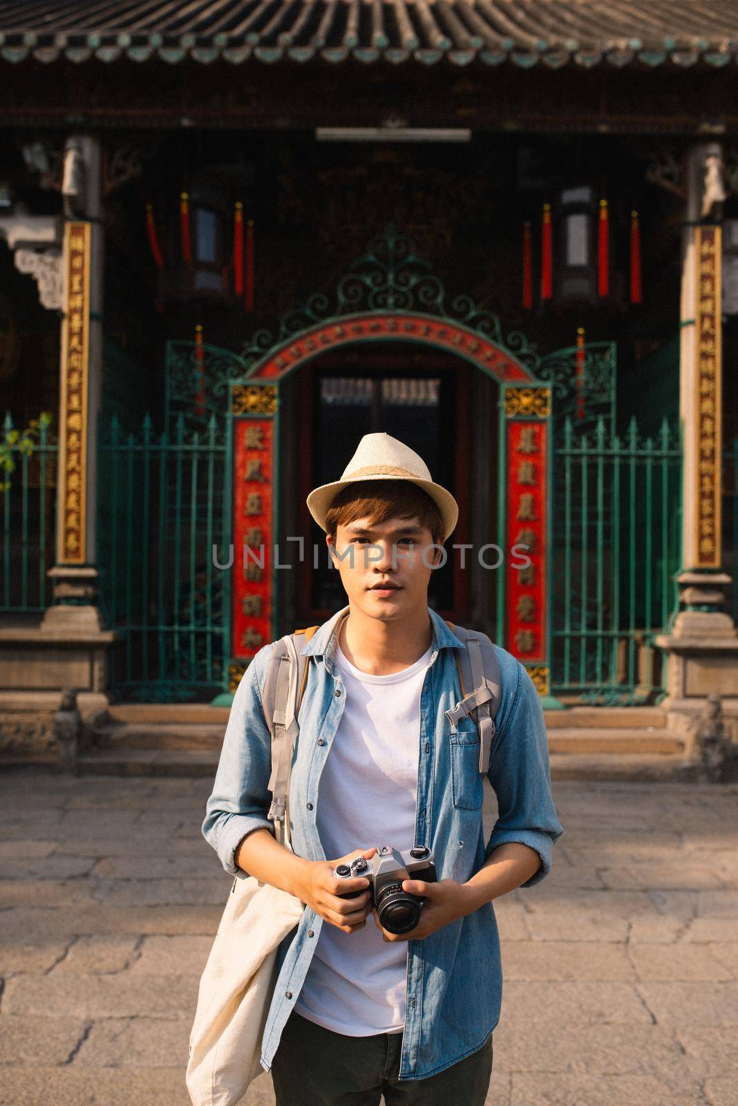 Young traveler taking pictures of the ancient city in asia style by makidotvn