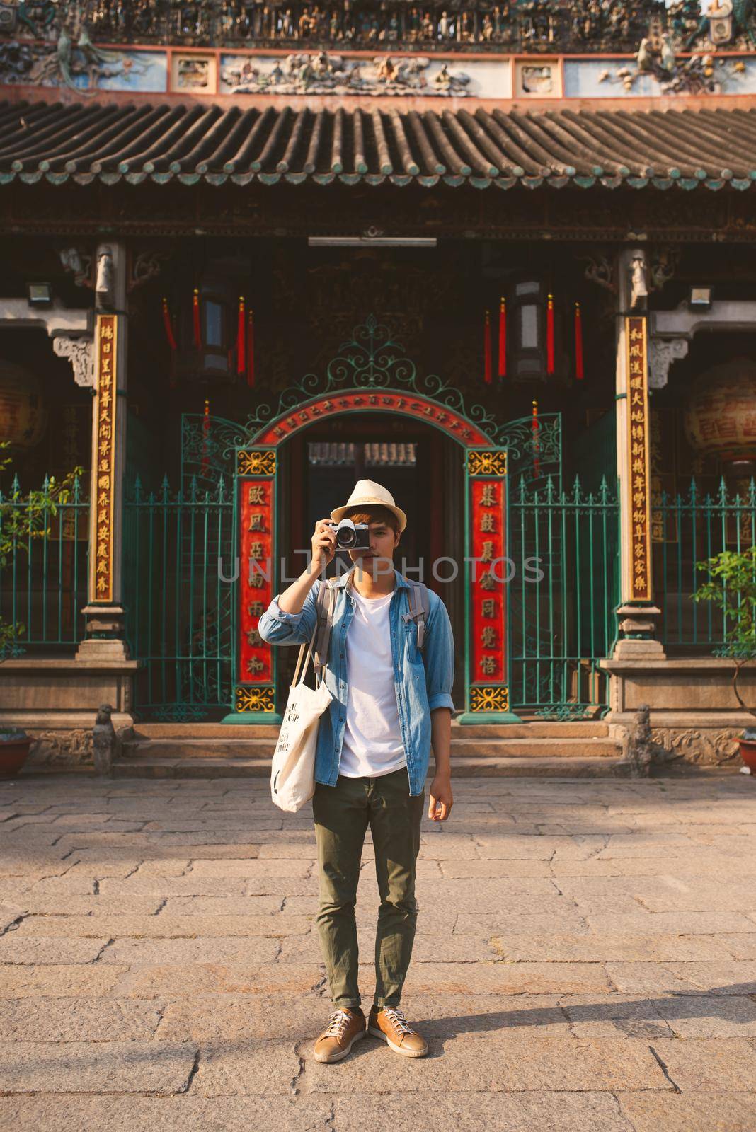 Young traveler taking pictures of the ancient city in asia style