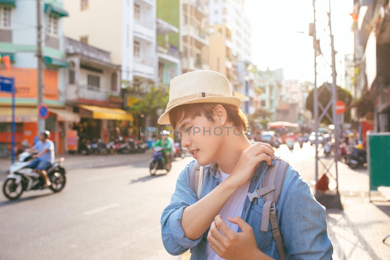 Male traveller carry heavy bags, look with tired expression after long trip