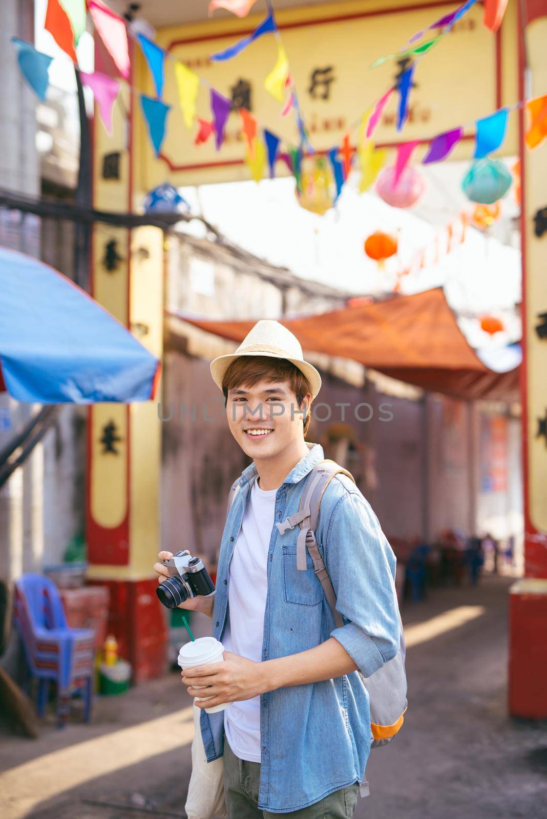 Young asian man traveler shopping walking on street market