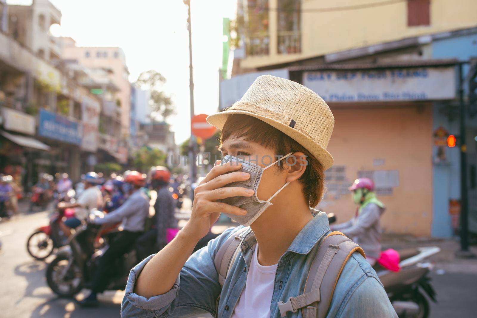 Young Asian man living in city with polluted air