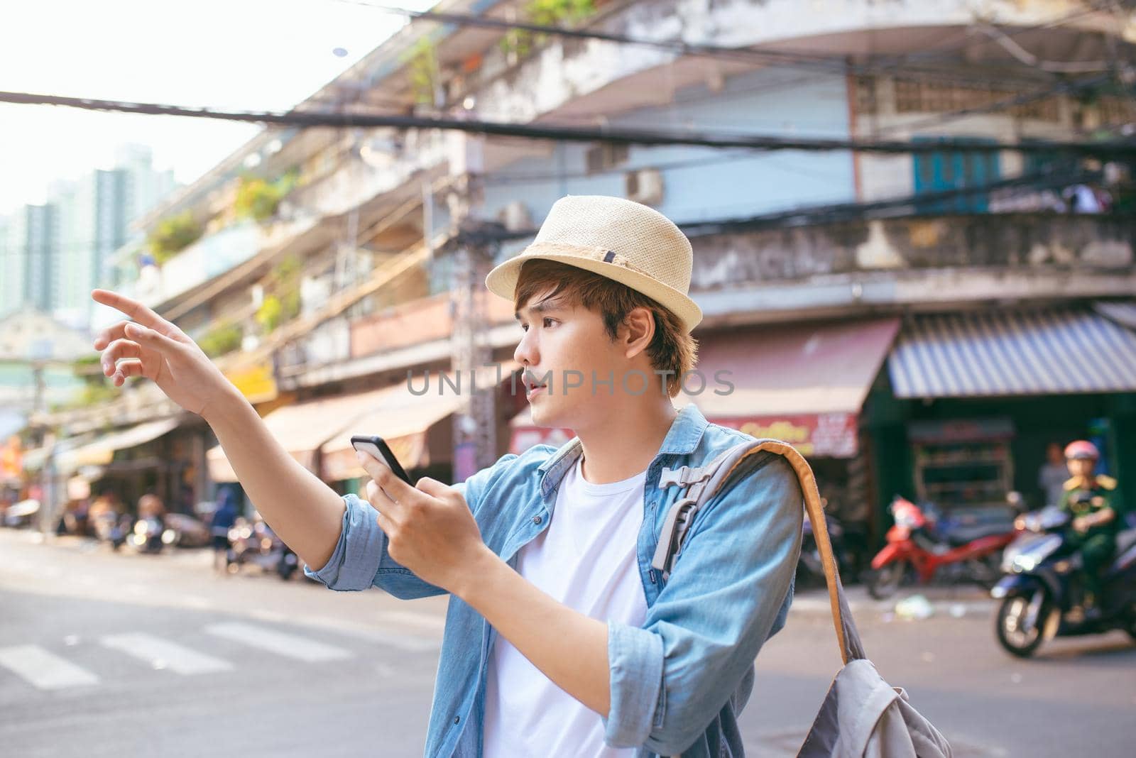 Tourism and technology. Concept of online map. Traveling backpacker young man using digital tablet outdoor.
