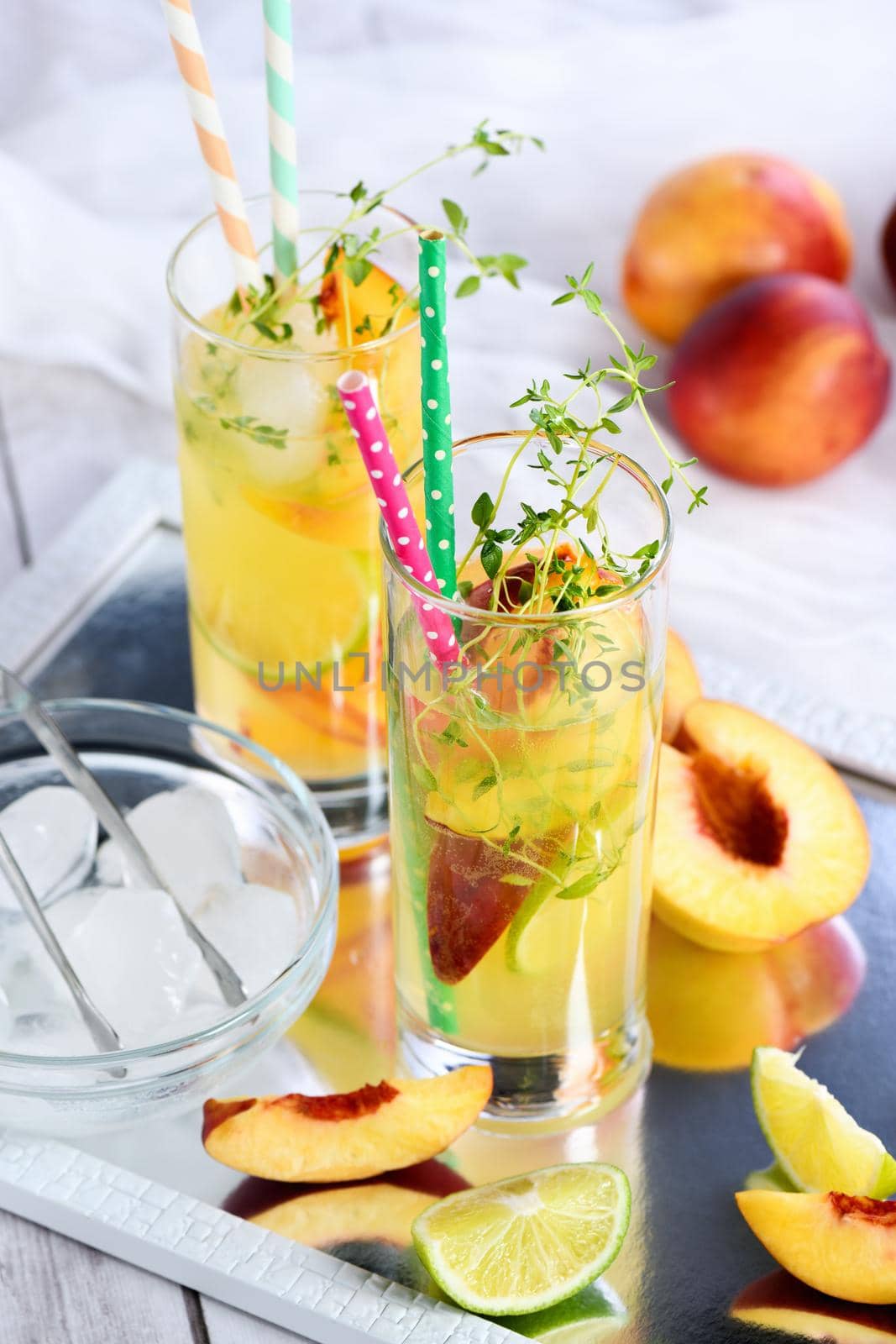 Peach summer cocktail. Refreshing organic non-alcoholic drink, lemonade with ripe nectarine, thyme and lime  