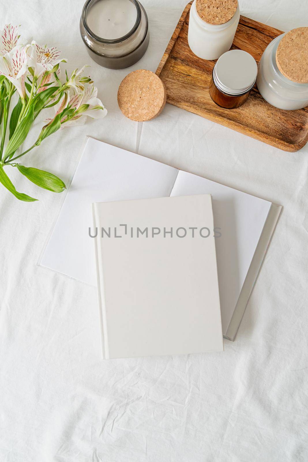 Blank white book, coffee , flowers on white bed, flat lay, mock up, flat lay