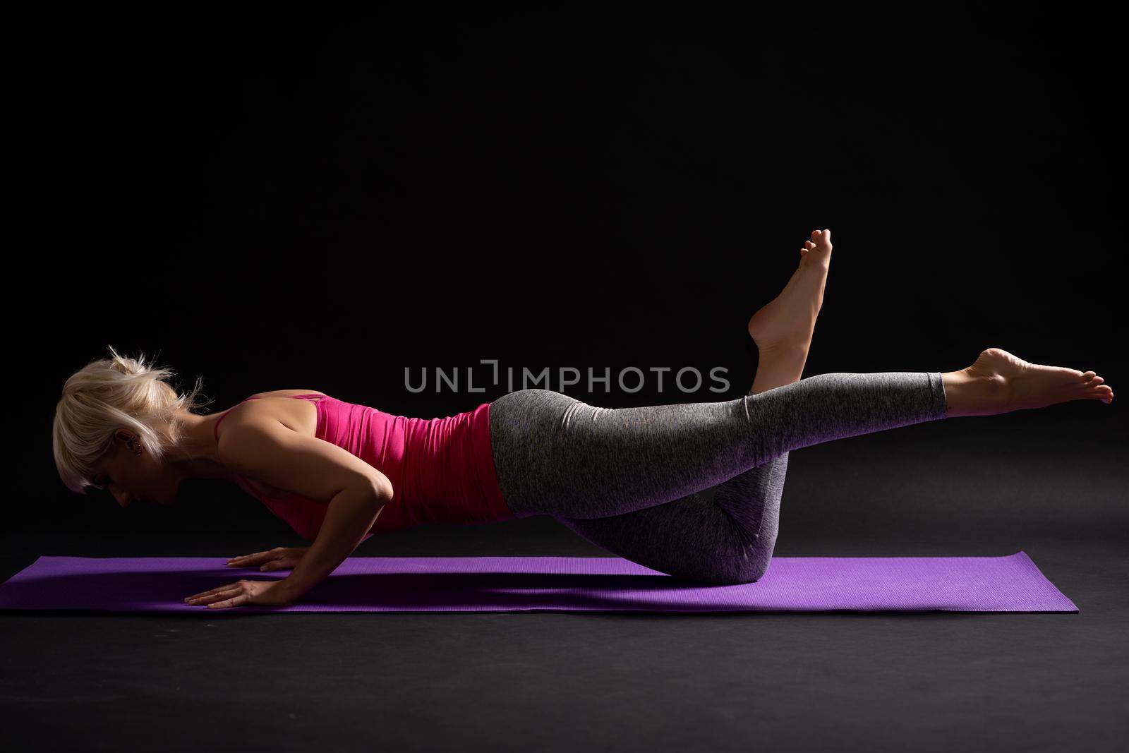 Woman exercising pilates. Exercise for body health.