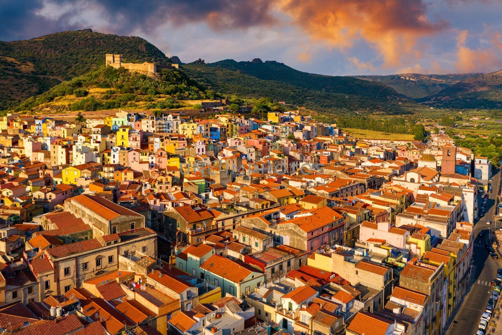 Aerial view of the beautiful village of Bosa with colored houses and a medieval castle. Bosa is located in the north-wesh of Sardinia, Italy. Aerial view of colorful houses in Bosa village, Sardegna.