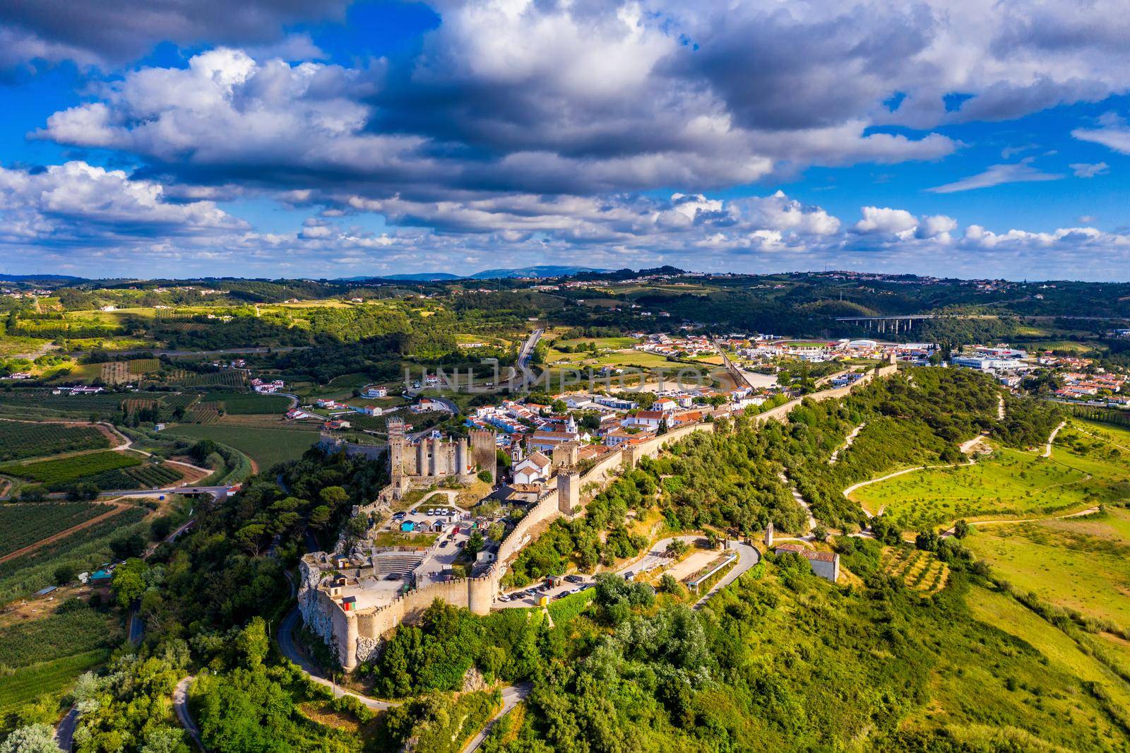 Aerial view of the historic walled town of Obidos at sunset, near Lisbon, Portugal. Aerial shot of Obidos Medieval Town, Portugal. Aerial view of medieval fortress in Obidos. Portugal.