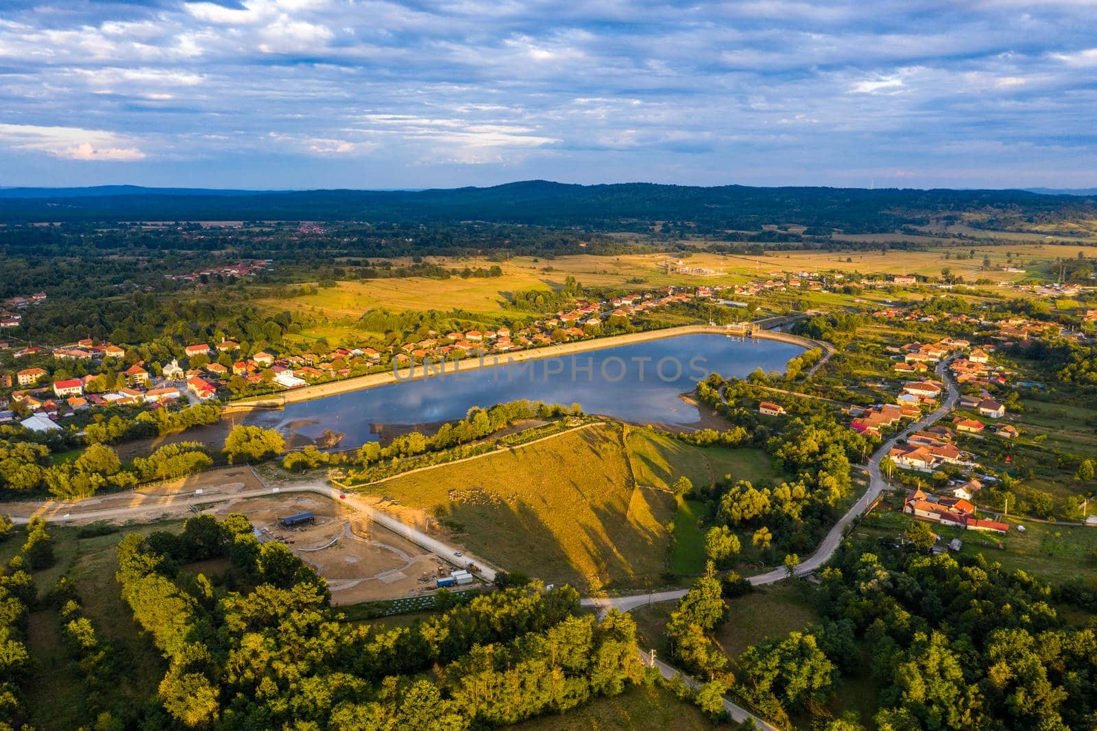 Beautiful Tismana lake and surrounding forest aerial panorama. Tismana, Romania.