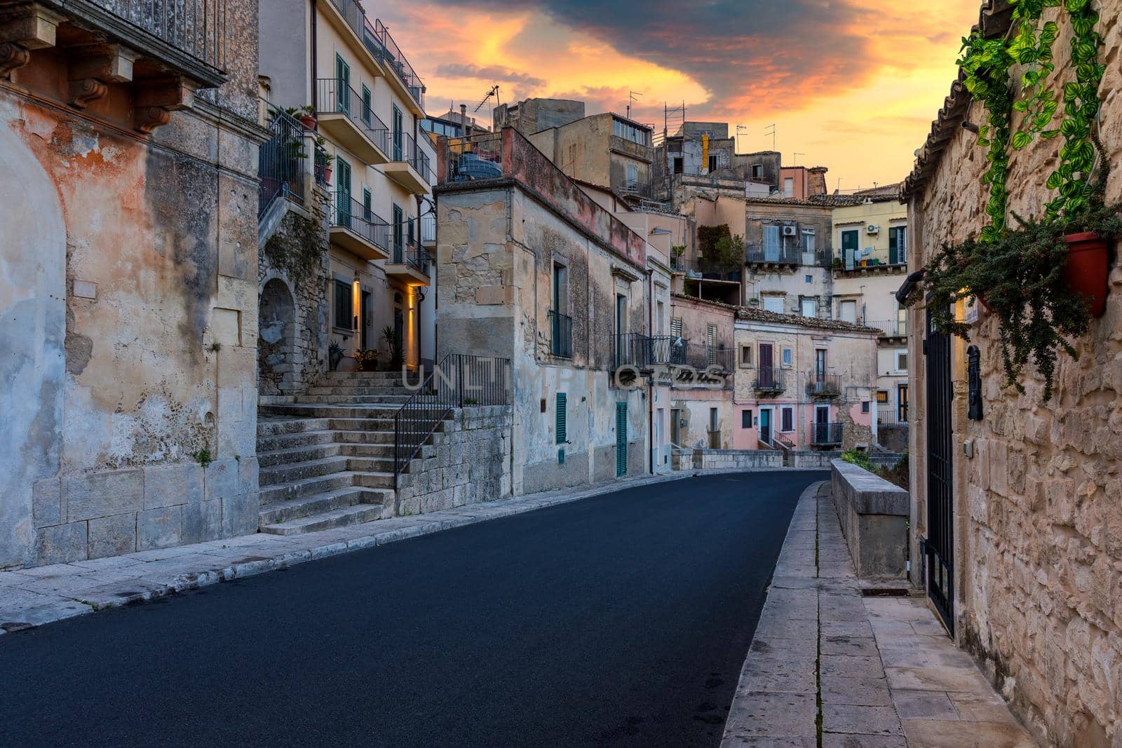 Narrow typical italian old street in Ragusa (Ragusa Ibla), Sicily, Italy , UNESCO heritage town on Italian island of Sicily. View of the city Ragusa Ibla, Val di Noto, Sicily, Italy.  