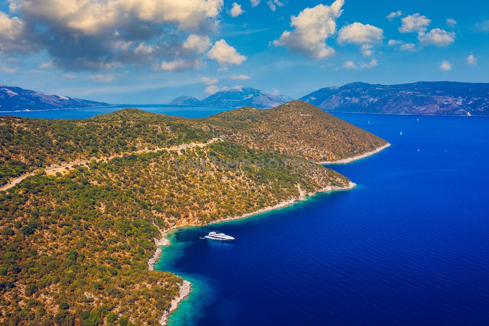 White sail boat isolated in blue sea water. Sailboat in the sea in the sunlight, luxury summer adventure, active vacation in Mediterranean sea. Yacht sailing on opened sea. Sailing boat. 