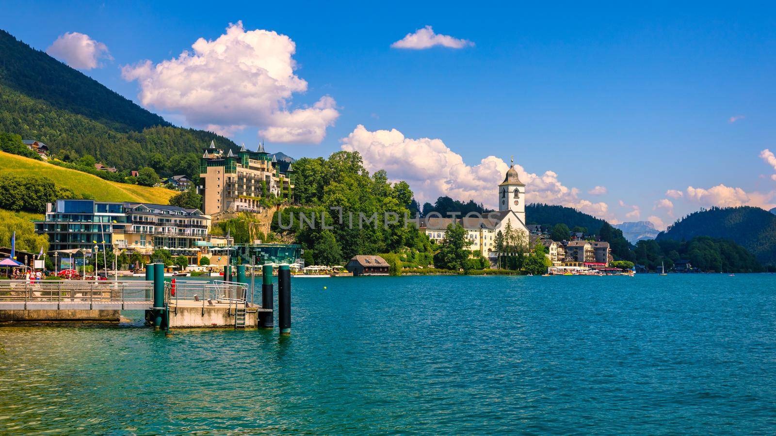 Embankment promenade at the Wolfgangsee lake in Austria. Wolfgangsee is one of the best known lakes in the Salzkammergut resort region of Austria. Village St Wolfgang on the lake Wolfgangsee, Austria