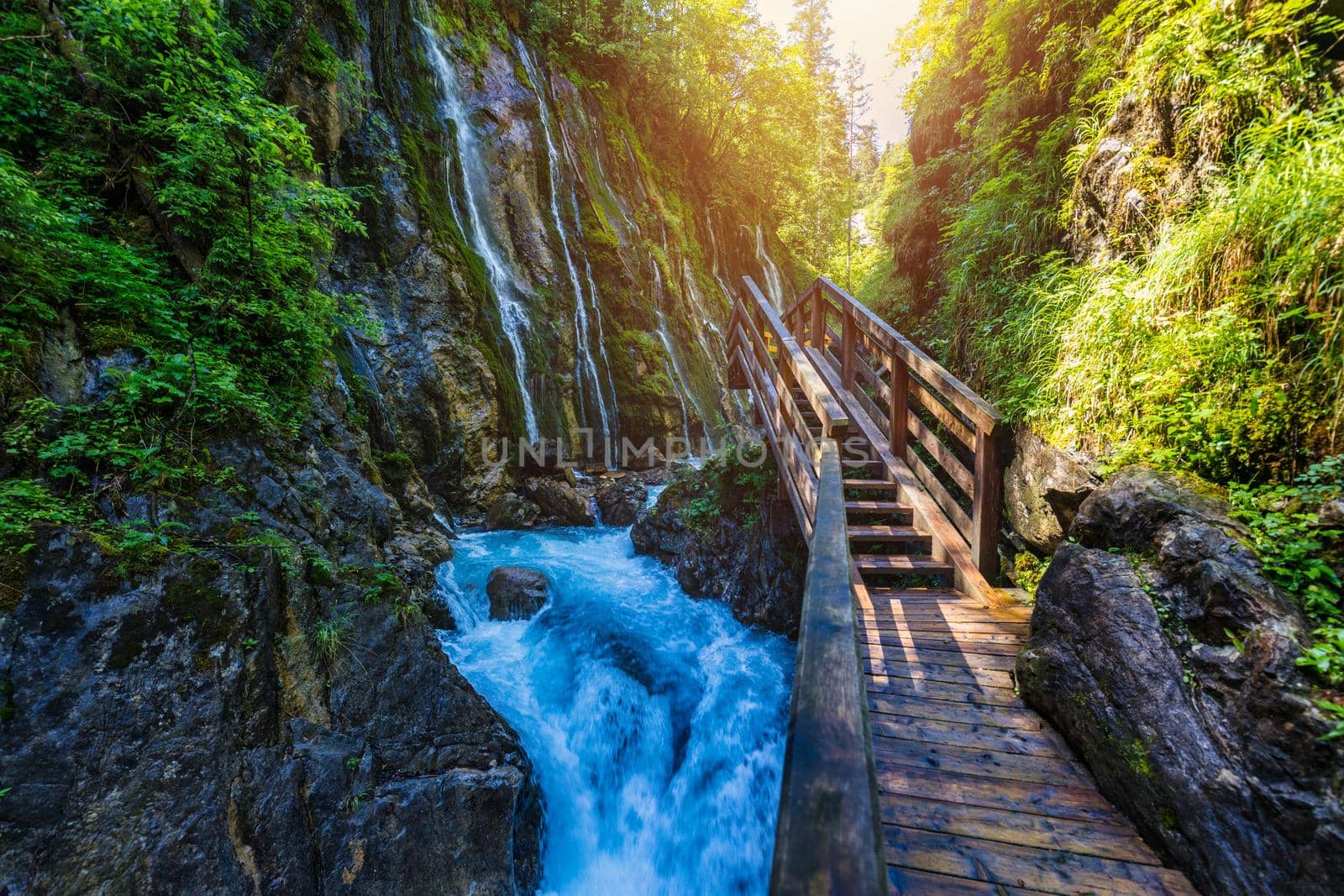 Beautiful Wimbachklamm gorge with wooden path in autumn colors, Ramsau bei Berchtesgaden in Germany. Waterfall at Wimbachklamm near Ramsau-Berchtesgaden, Bavaria, Germany.