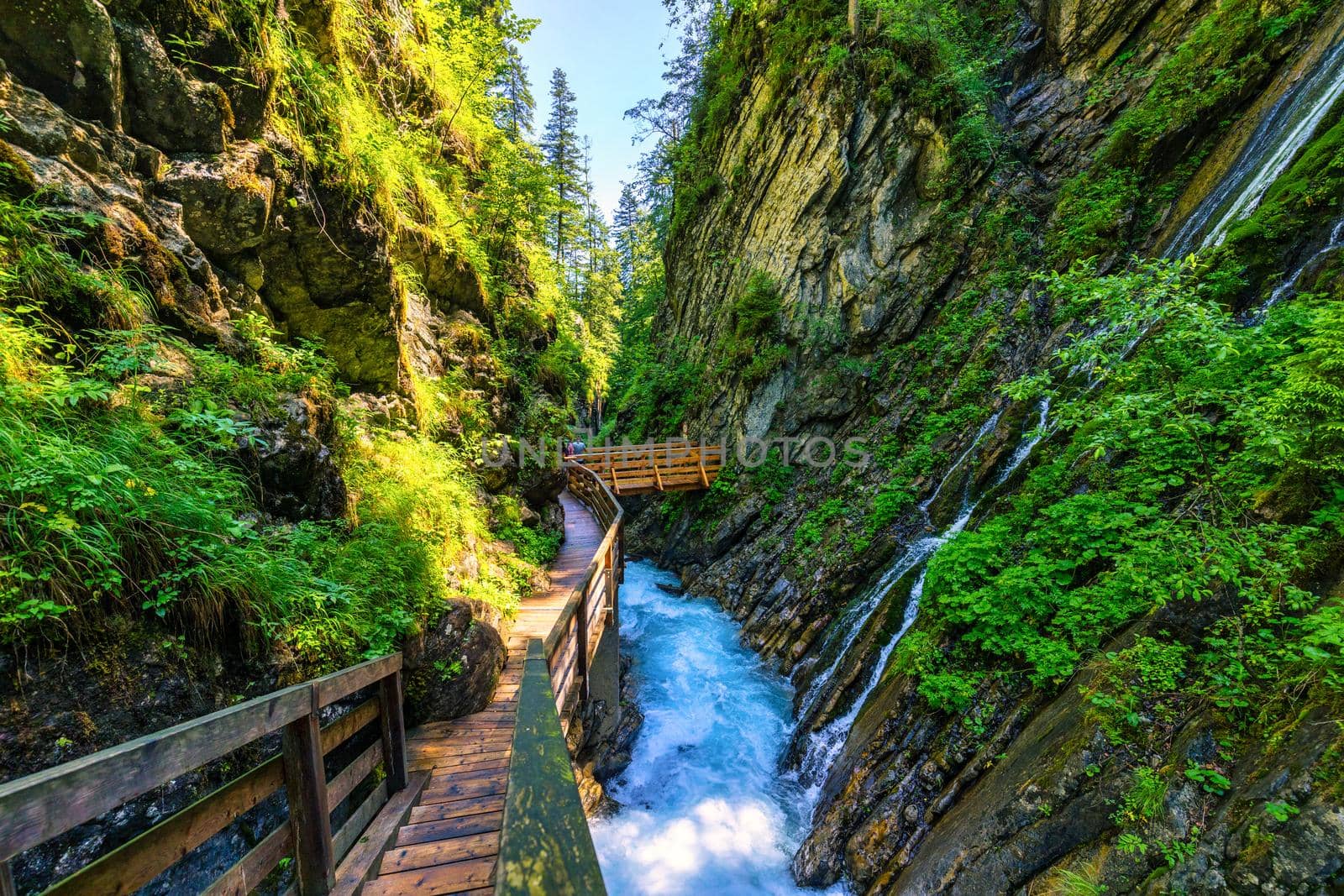 Beautiful Wimbachklamm gorge with wooden path in autumn colors, Ramsau bei Berchtesgaden in Germany. Waterfall at Wimbachklamm near Ramsau-Berchtesgaden, Bavaria, Germany.