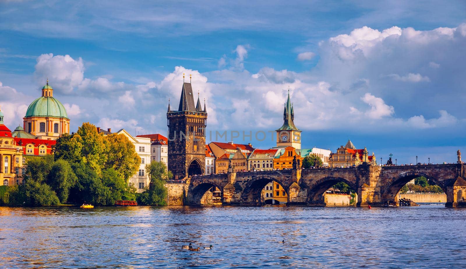 Prague in a sunny day, view of the old town, Prague, Czech Republic. Scenic summer view of the Old Town pier architecture and Charles Bridge over Vltava river in Prague, Czech Republic
