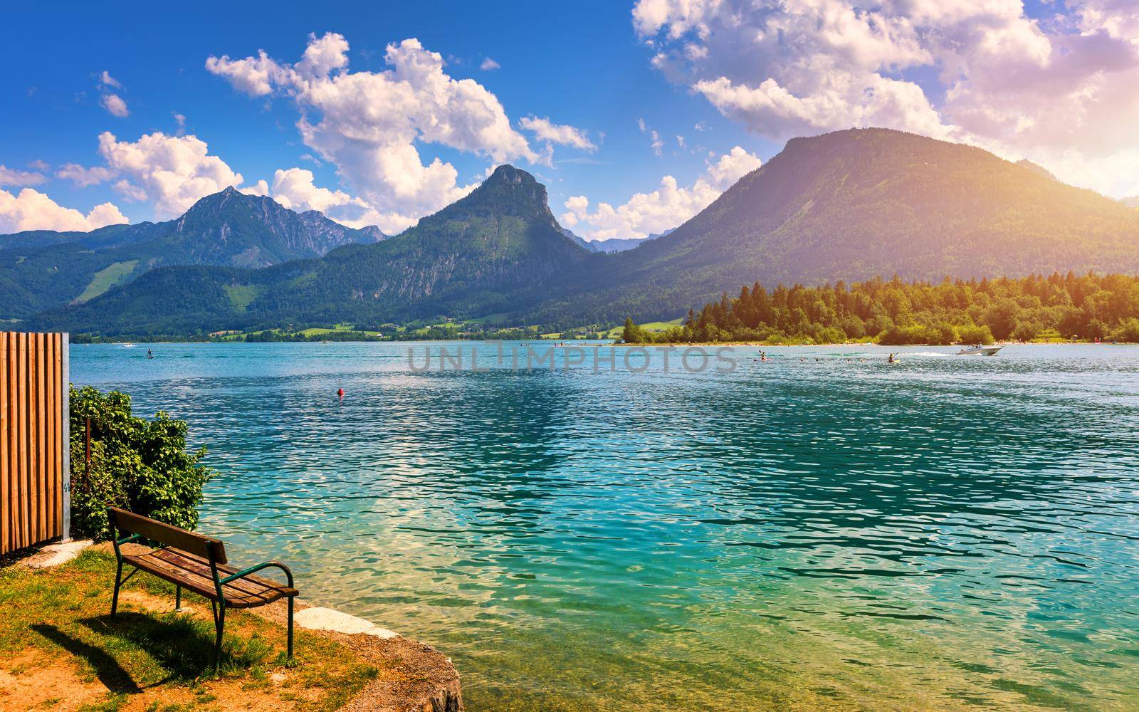 Embankment promenade at the Wolfgangsee lake in Austria. Wolfgangsee is one of the best known lakes in the Salzkammergut resort region of Austria. Village St Wolfgang on the lake Wolfgangsee, Austria
