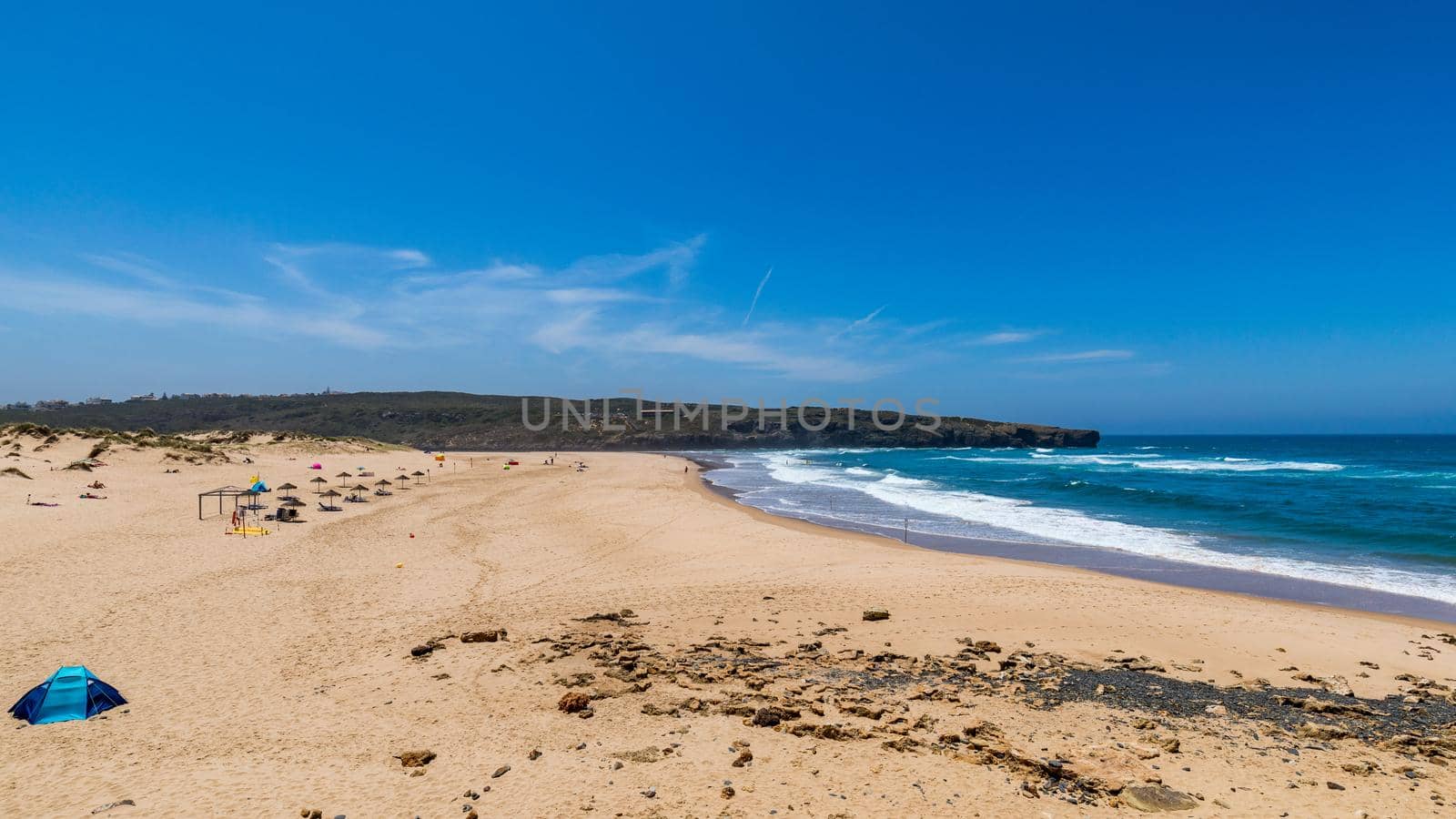 Wooden walkway to the beach Praia da Amoreira, District Aljezur, Algarve Portugal. Panorama from Amoreira beach in the Algarve Portugal. Beach and estuary of the Aljezur river, Praia da Amoreira.