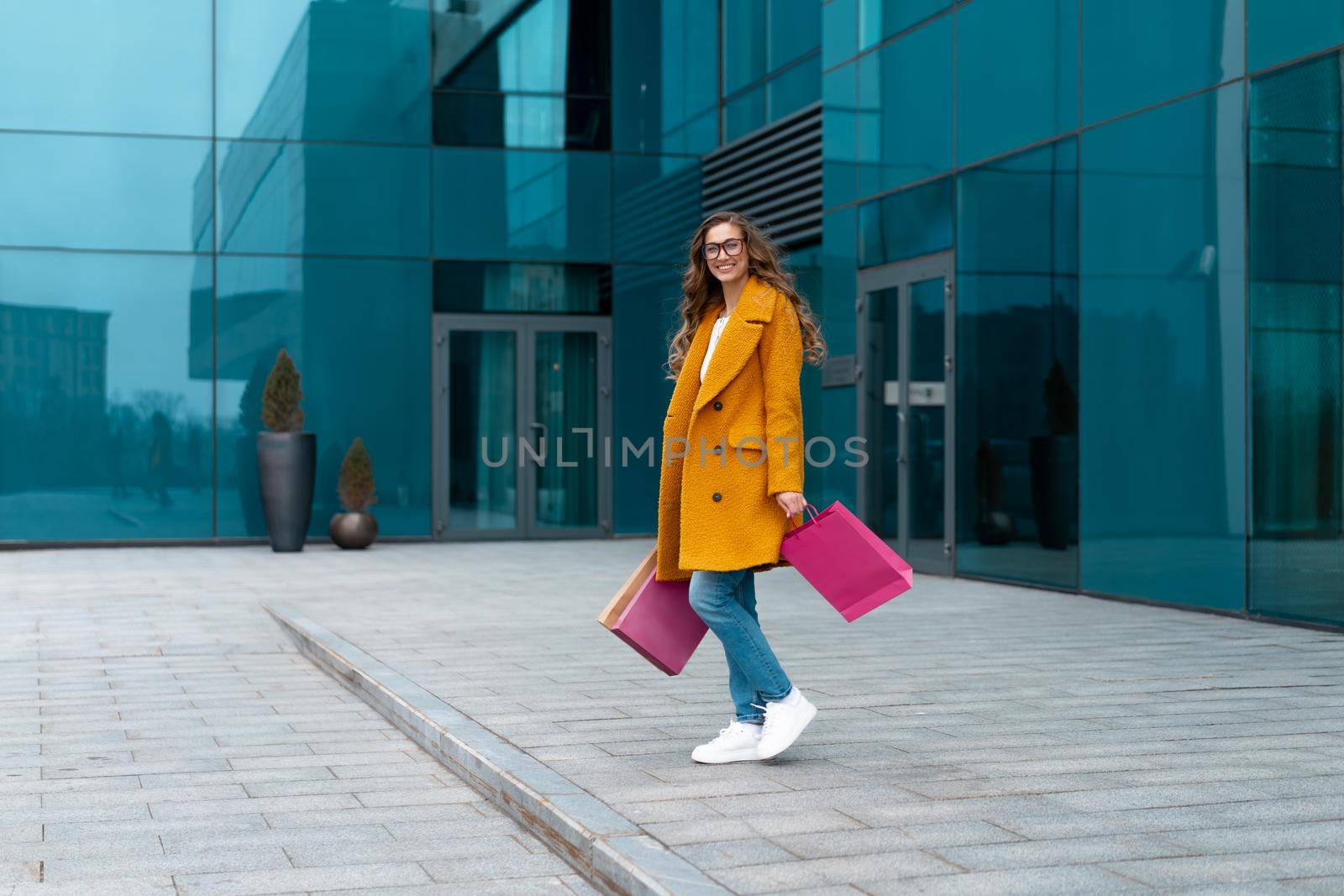 Business Woman With Shopping Bags Dressed Yellow Coat Walking Outdoors Corporative Building Background Caucasian Female Business Person Office Building Stylish Businesswoman Season Sale full length