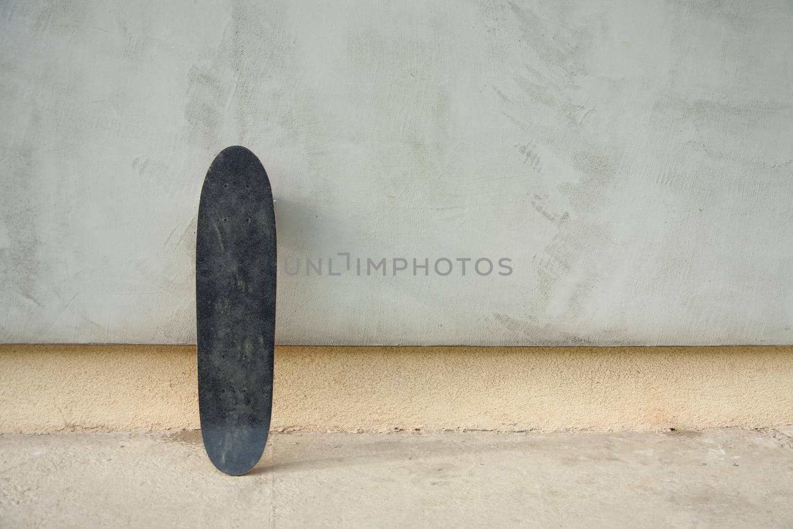 Skateboard on a wall. Used skateboard.