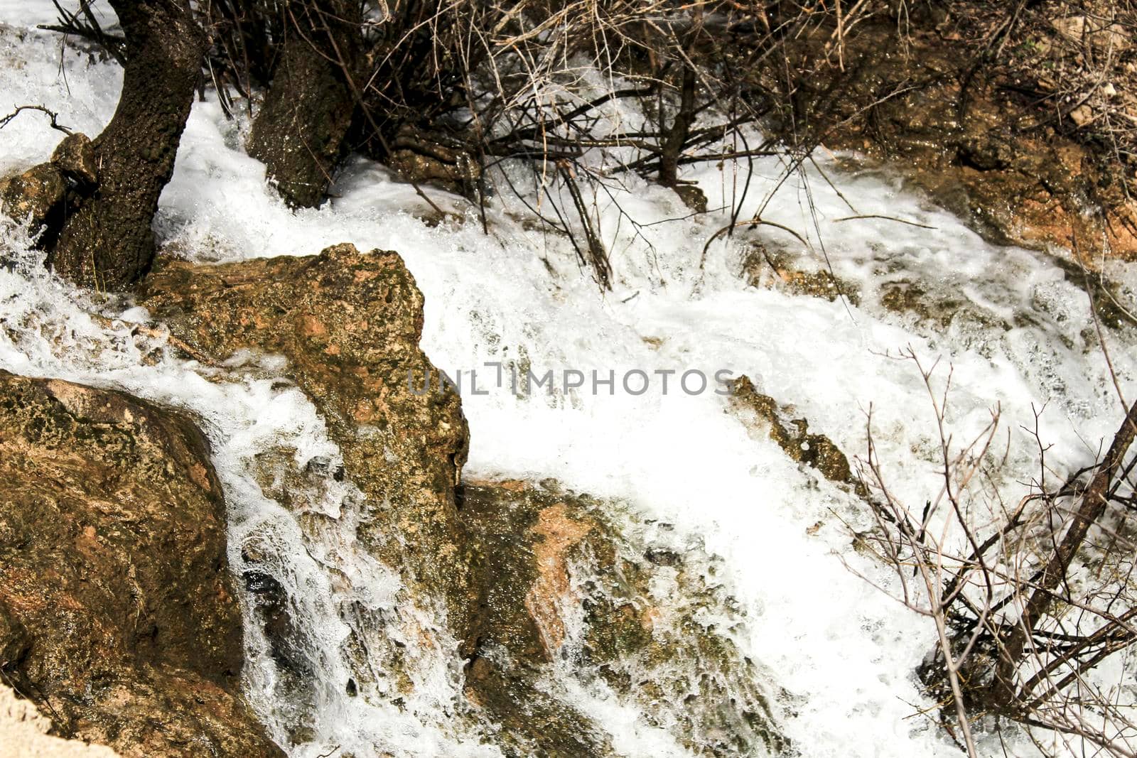 The Cabriel River with crystal clear waters and surrounded by green vegetation in the mountains of Albacete, Spain
