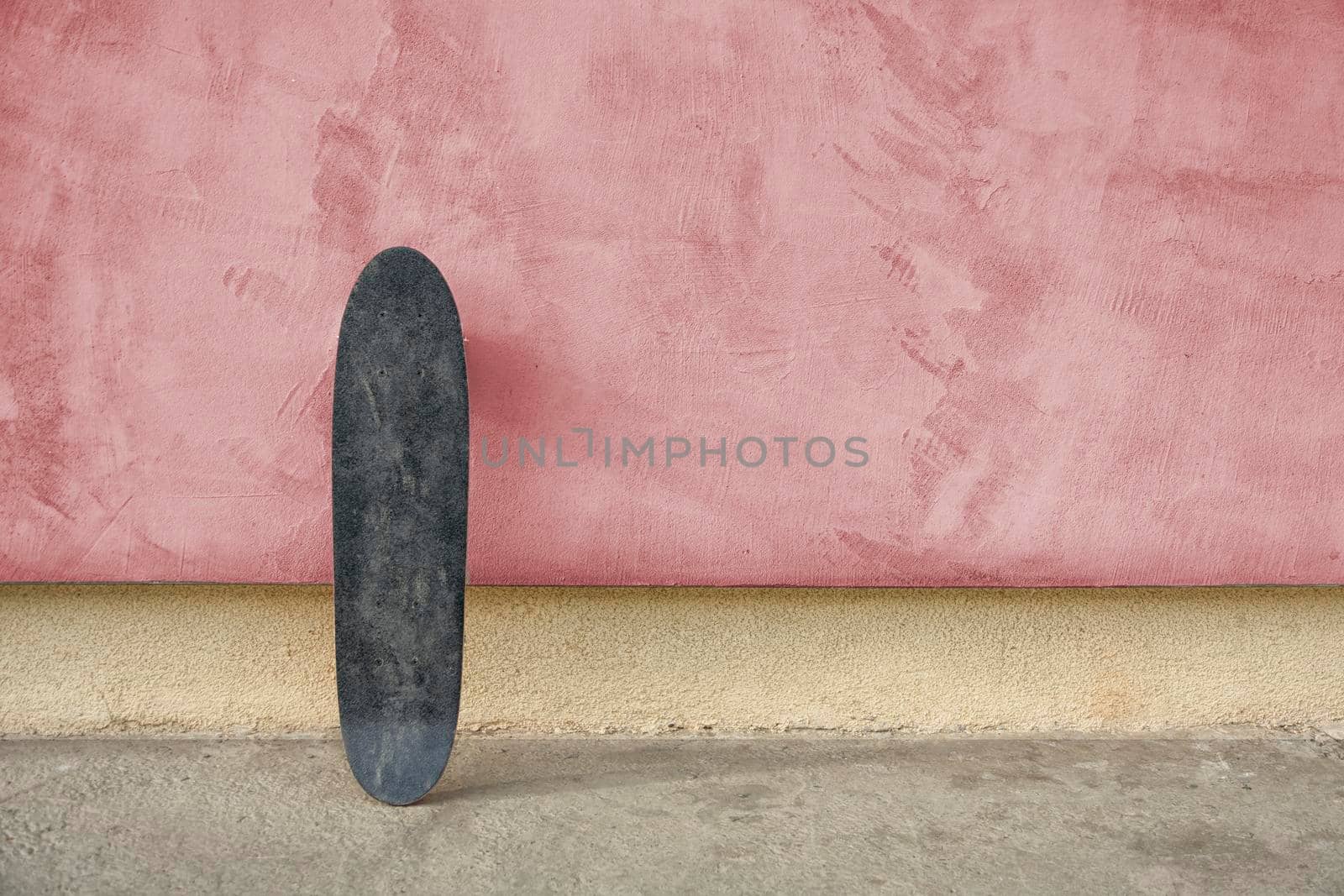 Skateboard on a wall. Used skateboard.