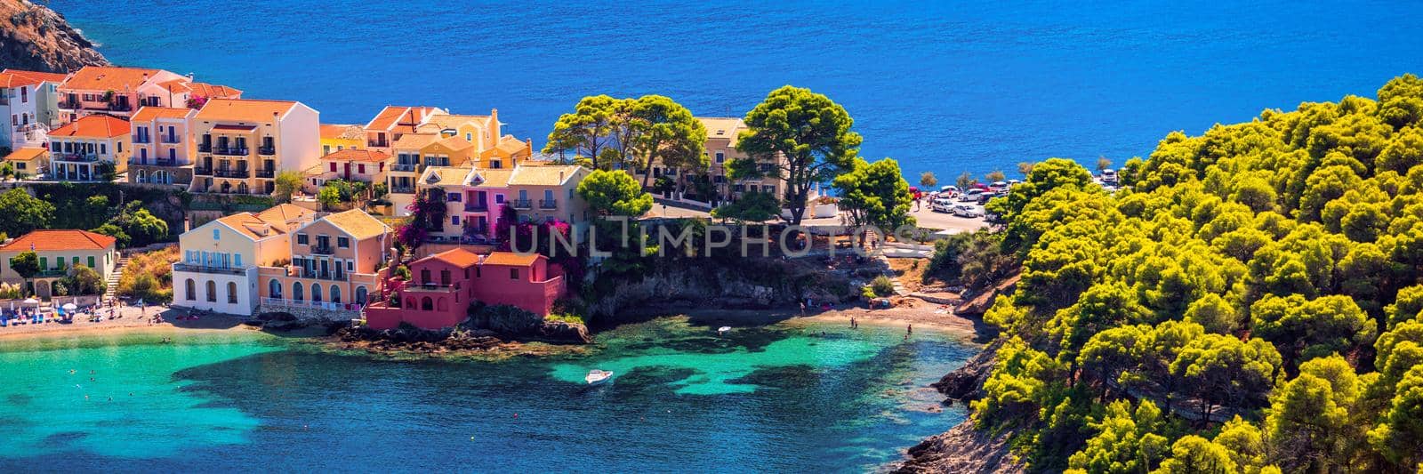 Assos village in Kefalonia, Greece. Turquoise colored bay in Mediterranean sea with beautiful colorful houses in Assos village in Kefalonia, Greece, Ionian island, Cephalonia, Assos village.