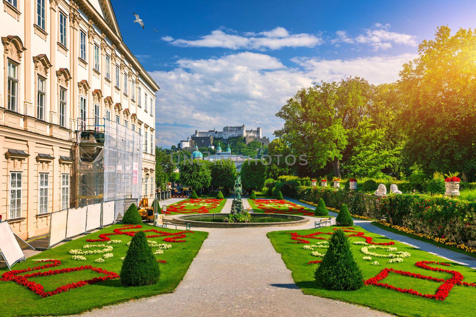 Beautiful view of famous Mirabell Gardens with the old historic Fortress Hohensalzburg in the background in Salzburg, Austria. Famous Mirabell Gardens with historic Fortress in Salzburg, Austria.