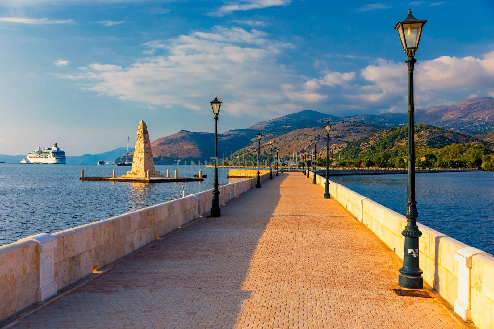 View of the De Bosset Bridge in Argostoli city on Kefalonia island. De Bosset Bridge on lakeside In Argostoli, Kefalonia. Obelisk and the de Bosset bridge in Argostoli, Kefalonia, Greece