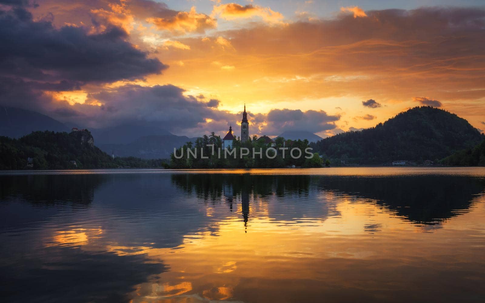 Lake Bled Slovenia. Beautiful sunrise over Bled lake with small Pilgrimage Church. Most famous Slovenian lake and island Bled with Pilgrimage Church of the Assumption of Maria. Bled, Slovenia.